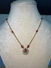 Simple golden chain with red ruby stone