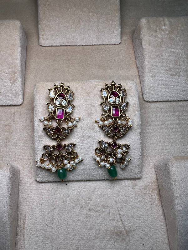 Golden earrings with pink meenakari and green beads