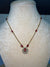 Simple golden chain with red ruby stone