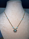 Golden chain with baby blue stone