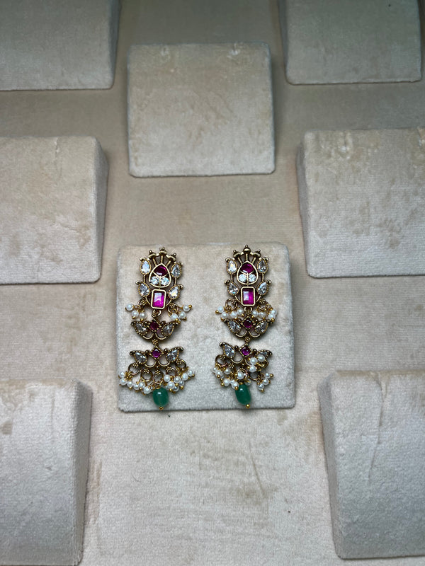 Golden earrings with pink meenakari and green beads